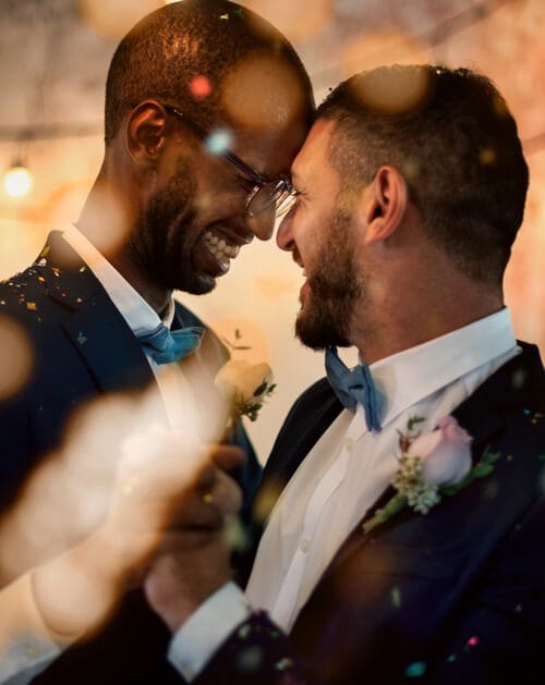 Smiling couple dancing with light glowing around them